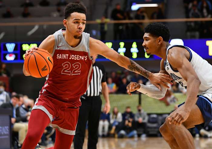 Saint Joseph's Hawks forward Jordan Hall (22) dribbles the ball against Villanova Wildcats forward Jermaine Samuels (23) in the second half at William B. Finneran Pavilion.